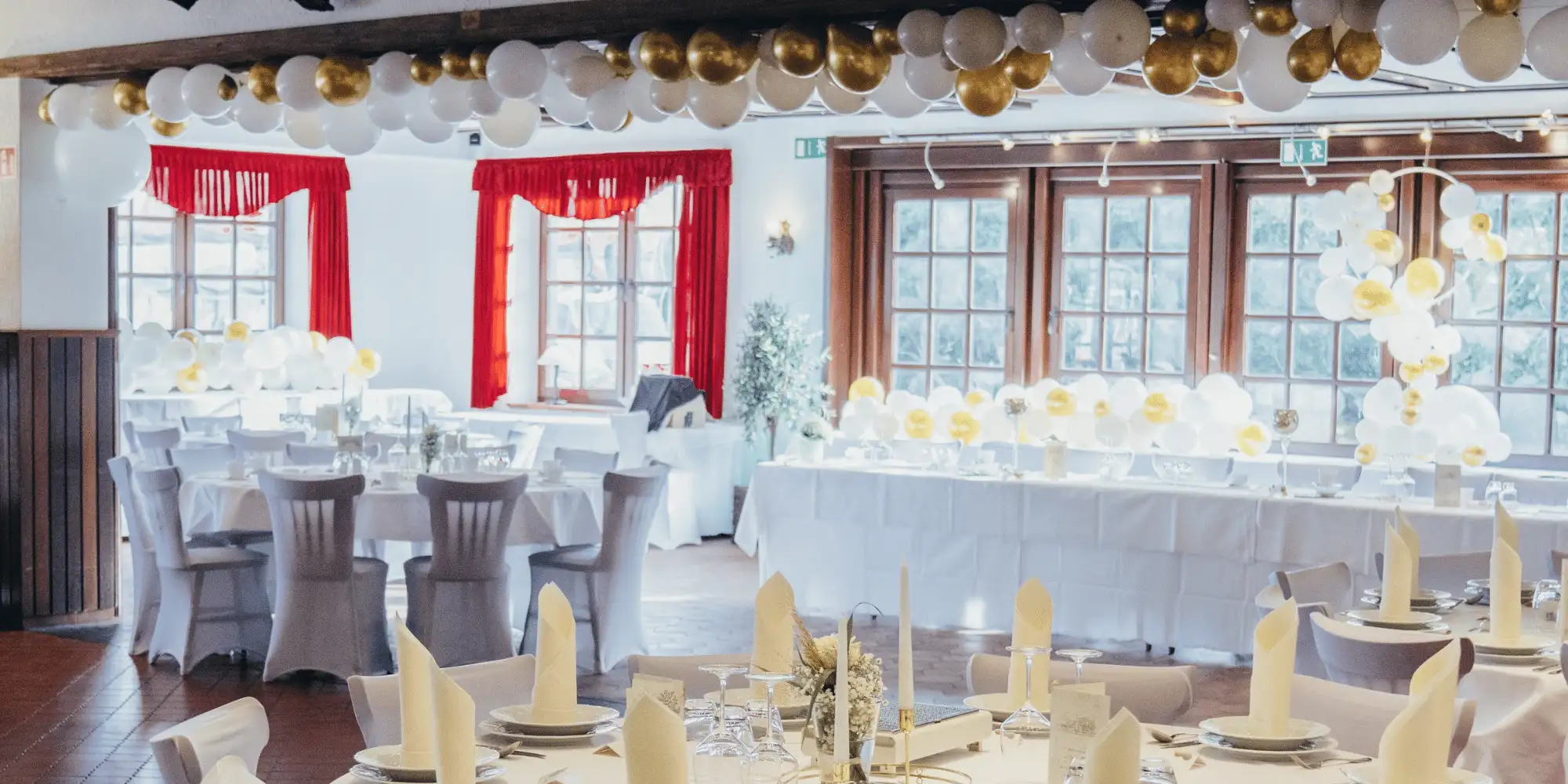 Festlich gedeckte Hochzeitstafeln mit Ballondekoration im Langenhorster Hof